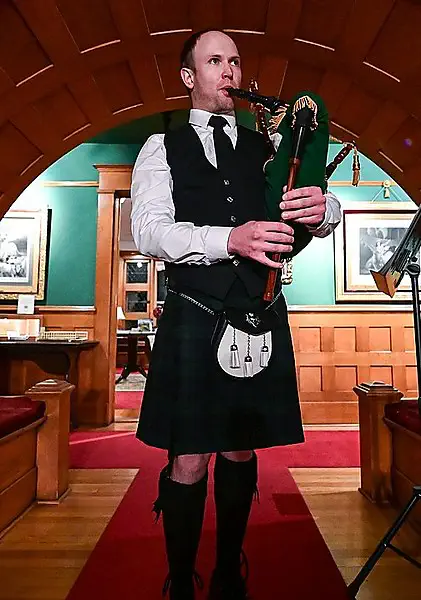 A piper performing indoors