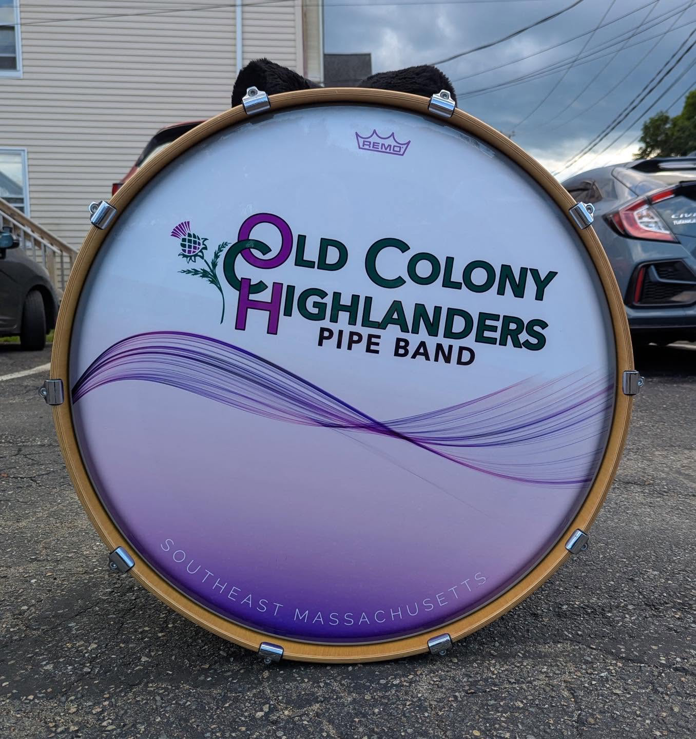 Old Colony Highlanders Pipe Band bass drum with purple and green band lettering