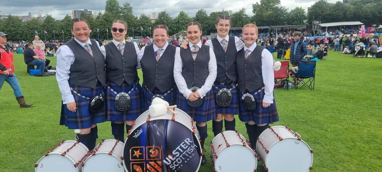Ulster Scottish band members gathered with their bass and tenor drums